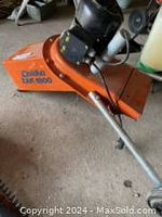 Right side view showing orange infeed chute with Lescha ZAK 1800 logo and front wheel assembly