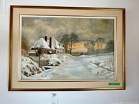 Framed oil painting showing a British winter scene with snow covered roofs, trees, and a sunset sky.