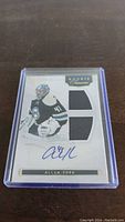 Front of Allen York rookie hockey card featuring autograph and two patches.