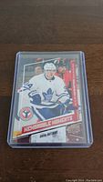 Front-facing photo of Auston Matthews rookie hockey card in a clear plastic protective case.