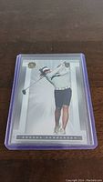 Front of Brooke Henderson golf trading card showing golfer swinging club.