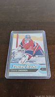 Front view of Charlie Lindgren Young Guns hockey card showing player in goalie gear.