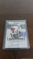 Front side of rookie hockey card showing Colin Greening in Ottawa Senators uniform with autograph.