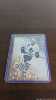 Front of Danny Markov hockey card in Toronto Maple Leafs uniform with autograph and purple protective sleeve.