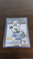 Front view of the Drake Batherson autographed hockey card showing the player in white Ottawa Senators jersey with number 19 and blue autograph.