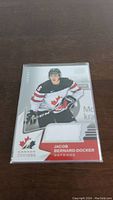 Front of the Jacob Bernard-Docker hockey jersey card showing player image and embedded white fabric patch beneath.