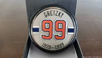 Front of the puck showing 'Gretzky', number '99', and years '1979 - 1999' design.
