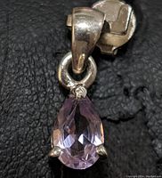 Front view of the sterling silver amethyst pendant showing the light purple faceted gemstone and silver setting.