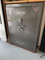 Front exterior view showing Cannon logo, electronic keypad, chrome handle