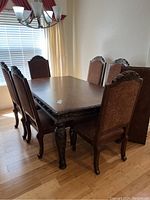 Dining table and six upholstered chairs in a dining room setting