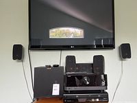 Group shot showing LG TV mounted above Klipsch speakers, subwoofer, Yamaha receiver and Panasonic player