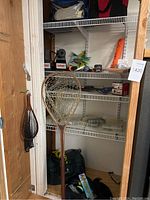 Full closet view showing landing nets, tackle bags and shelves