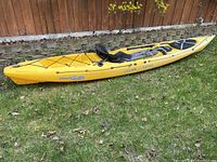 Side view of kayak on grass showing full length and overall shape