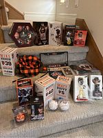 Full overview of all SF Giants collectibles on stairs showing bobbleheads, baseballs, apparel, and memorabilia.