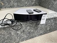 Front view of silver Bose Wave Music System II on marble surface, power cable visible