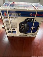 Front of sealed box with straps showing model image and branding