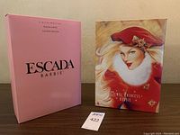 Photo of the original boxed limited edition Escada Barbie and Jewel Princess Barbie dolls side by side showing box fronts.