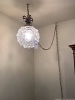 Full view of hanging bubble globe lamp showing glass shade and metal chain