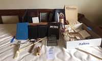 Full view of lot on white cloth showing all religious books, crosses, jewelry, and paper items.