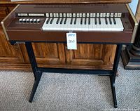 Front view showing keyboard, control buttons numbered 1 to 22, and black stand