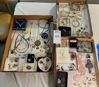 Overview of tray showing necklaces, pendants, earrings, bracelets and porcelain ring holder
