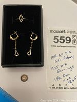 Photo showing 14kt yellow gold diamond ring, sterling 925 diamond earrings with dangle, and 10kt GF diamond Rotary pin (pin part missing). Included is a MaxSold lot number card and ruler for scale.
