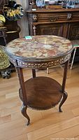 Full view of round marble top accent table showing base and top