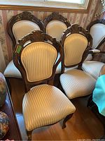 Group of six chairs arranged under window