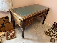 Three-quarter left view showing overall form, glass top, side drawer stack and fluted leg