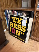 Photo of Salt-N-Pepa 'Expression' vinyl LP album front cover and other vinyl records in storage shelf