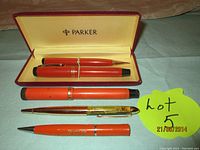 Two Parker Duofold items in original Parker case – red fountain pen and matching pencil