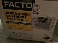 Photo of the Facto window air conditioner box showing capacity 5,200 BTU and refrigerant type R410A with technical specifications.