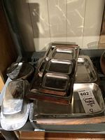 Photo showing all items in set including large rectangular tray, two smaller servers with teak handles, butter dish, and small bowl arranged on a surface