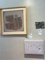 Both artworks displayed on wall with lot tags visible