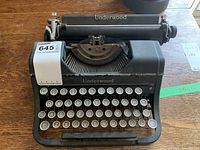 Front angle showing full keyboard, Underwood brand name on paper holder and front, presence of a label with lot number.