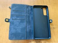 Open view showing interior card slots and black cradle for Samsung Galaxy S21 phone, magnetic snap closure visible.