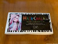 Top of packaging box showing branding and color usage example