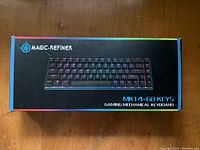 Photo of boxed Magic-Refiner MK14 68-key mechanical gaming keyboard with RGB lighting shown on box.