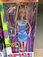 Front view of the unopened Spice Girls Barbie doll in original packaging. Doll dressed in blue satin dress with blonde pigtails.