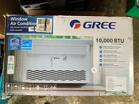 Box front showing Gree branding, 10,000 BTU, and product image of air conditioner with remote control. Shows Energy Star rating and features like programmable digital thermostat.