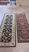 Both runner rugs displayed side by side on a concrete floor showing full length and pattern, illustrating overall condition and size difference.