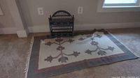 Full view of area rug placed on carpeted floor with wicker wall shelf positioned behind it