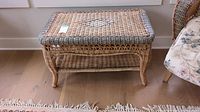 Rectangular wicker table with woven pattern and lower storage shelf