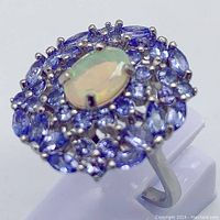 Close-up tilted view highlighting the color and clarity of the opal and tanzanites