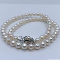 Coiled pearl necklace showing pearls and silver filigree clasp