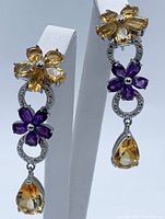 Full view of both citrine and amethyst dangle earrings showing floral design and gemstone details
