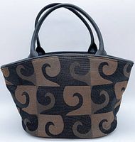 Front view of the Pierre Cardin mini handbag showing brown and black geometric swirl pattern fabric with black handles and trim.