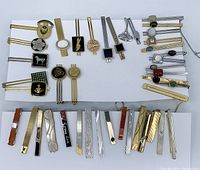 Overall layout showing top and bottom rows of all 28 tie clips on white background