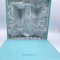 Set of two clear champagne and wine glasses in Tiffany & Co. blue presentation box with satin lining.