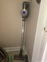 Assembled Dyson V6 Full Kit cordless vacuum mounted on wall